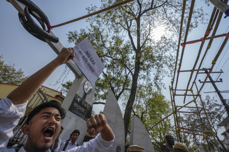 Students protest against the Citizenship Amendment Act (CAA) in Guwahati, India, Tuesday, March 12, 2024. India implemented a controversial citizenship law that was widely criticized for excluding Muslims, a minority community whose concerns have intensified under Prime Minister Narendra Modi A Hindu nationalist government.  The act provides fast-track naturalization for Hindus, Parsis, Sikhs, Buddhists, Jains and Christians who fled to Hindu-majority India from Afghanistan, Bangladesh and Pakistan before December 31, 2014. (AP Photo/Anupam Nath)