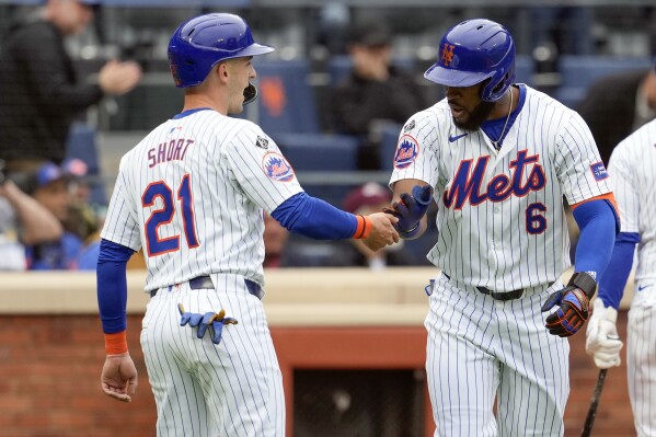 New York Mets' Starling Marte (6) celebrates with Zack Short (21) after they scored off of Marte's a two-run home run during the third inning of a baseball game against the Pittsburgh Pirates, Wednesday, April 17, 2024, in New York. (AP Photo/Mary Altaffer)