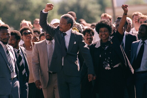 Nelson Mandela and wife Winnie, walking hand in hand, raise clenched fists upon his release from Victor prison, Cape Town, Sunday, February 11, 1990.  The African National Congress leader had served over 27 years in detention. (APPhoto)