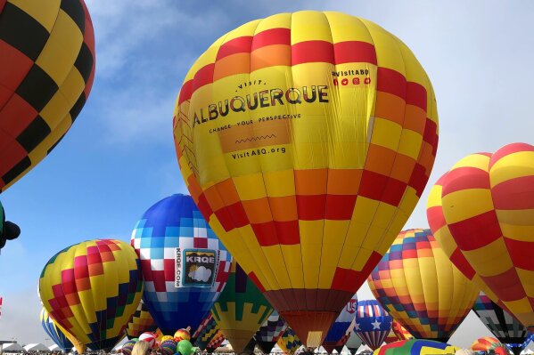 FILE - Hot air balloons are inflated during the annual Albuquerque International Balloon Fiesta in Albuquerque, N.M., on Saturday, Oct. 5, 2019. The Santa Fe Opera, Meow Wolf and the non-profit organization that puts on the Albuquerque International Balloon Fiesta are among the New Mexico businesses that received loans from the federal government as part of massive effort to support the economy amid the coronavirus outbreak. (AP Photo/Susan Montoya Bryan, file)