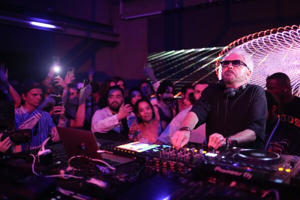 French musician Marc Cerrone performs during the DiscOlympics at Wanderlust night club at the 2024 Summer Olympics, Sunday, July 28, 2024, in Paris, France. (AP Photo/Natacha Pisarenko)