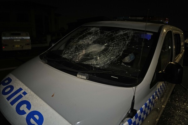 A Police car is seen vandalised outside a church where a bishop and churchgoers were reportedly stabbed in Sydney Australia, Monday, April 15, 2024. (AP Photo/Mark Baker)