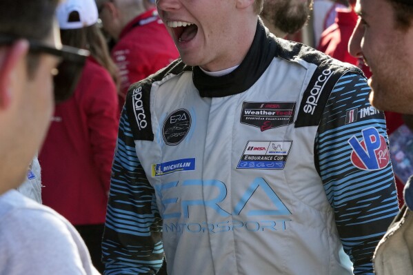 Connor Zilisch greets team members after the Rolex 24 hour auto race at Daytona International Speedway, Sunday, Jan. 28, 2024, in Daytona Beach, Fla. Connor Zilisch is coming off back-to-back sports car class victories at Daytona and Sebring and the teen sensation now turns his attention to NASCAR. (AP Photo/John Raoux)