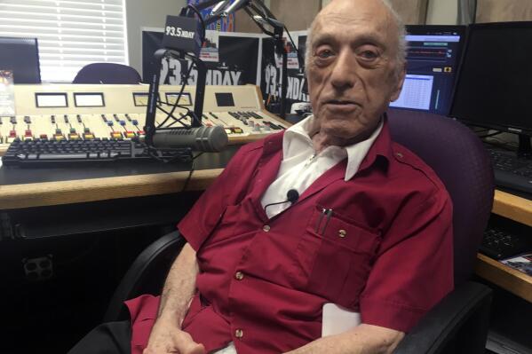 FILE - DJ Art Laboe sits in his studio and talks about his 75 years in the radio business on Oct. 9, 2018, in Palm Springs, Calif. Laboe, a pioneering disc jockey who hosted a syndicated oldies show for decades, died Friday, Oct. 7, 2022. Laboe is credited with helping end segregation in Southern California by organizing live DJ shows at drive-in eateries that attracted whites, Blacks and Latinos who danced to rock-n-roll. He was 97. (AP Photo/Russell Contreras, File)
