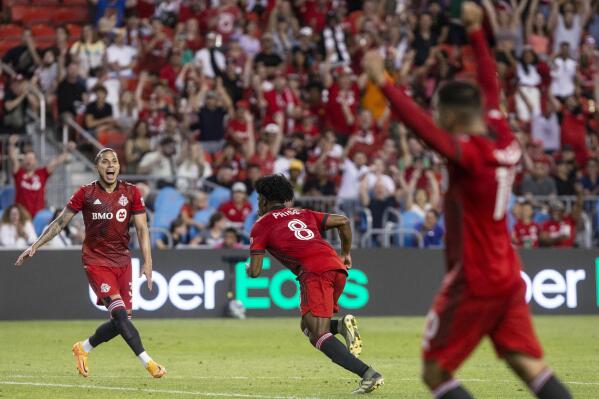 Toronto FC midfielder Ralph Priso (8) turns to Carlos Salcedo, left, after scoring against Atlanta United during the second half of an MLS soccer match Saturday, June 25, 2022, in Toronto. (Chris Young/The Canadian Press via AP)