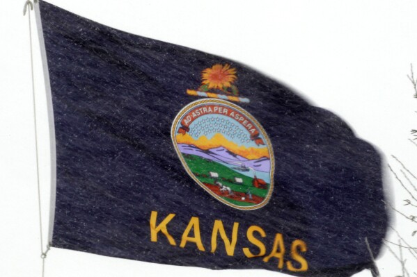 FILE - The Kansas state flag is pictured in Lawrence, Kan., Feb. 1, 2011. Kansas voters will choose their parties' nominees for House, state legislature and the state Board of Education in primaries on Tuesday, Aug. 6, 2024. The elections aren't likely to change the balance of power in Washington or Topeka, Kan., but many November races will essentially be determined in Tuesday's primaries in this heavily Republican state. (AP Photo/Orlin Wagner, File)