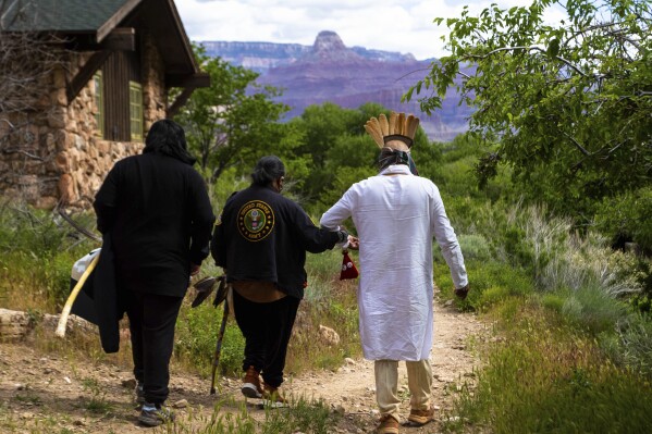 FILE - Members of the Havasupai Tribe walk down to a popular campground at Grand Canyon National Park, May 5, 2023. (AP Photo/Ty O'Neil, File)