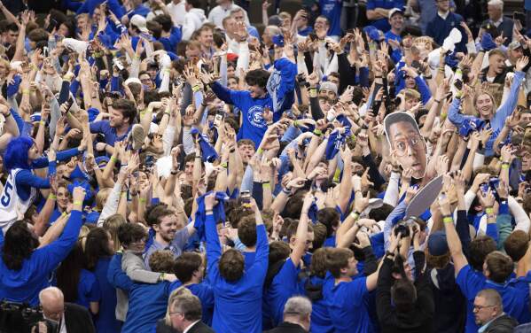 Creighton fans storm the court following the team's 85-66 win over UConn in an NCAA college basketball game Tuesday, Feb. 20, 2024, in Omaha, Neb. (AP Photo/Rebecca S. Gratz)