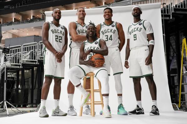 Milwaukee Bucks' Khris Middleton (22), Brook Lopez, second from left, Giannis Antetokounmpo (34), Bobby Portis (19) and Jrue Holiday, front center, pose for a photograph at the NBA basketball team's media day Sunday, Sept. 25, 2022, in Milwaukee. (AP Photo/Morry Gash)