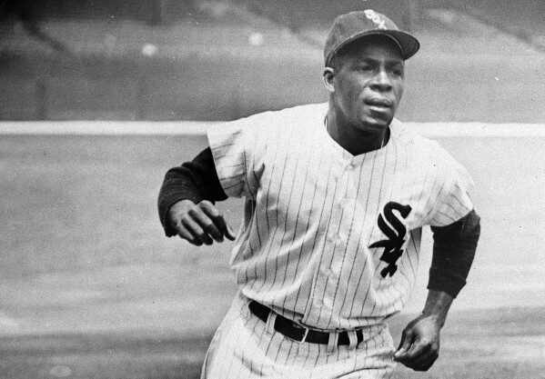 FILE - Minnie Minoso, Chicago White Sox outfielder, practices running the bases at Comiskey Park in Chicago, June 1, 1955. Minosa will be posthumously inducted into the Baseball Hall of Fame on Sunday, July 24, 2022. Major League Baseball said Tuesday, May 28, 2024, that it has incorporated records for more than 2,300 Negro Leagues players following a three-year research project. Miñoso was credited with 150 hits with the New York Cubans of the second Negro National League from 1946-1948, raising his total to 2,113. (AP Photo/File)