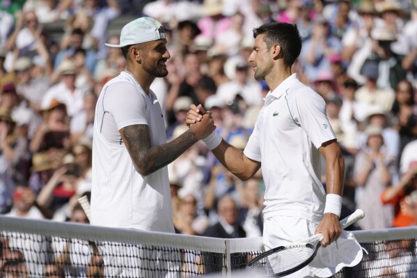 Serbia's Novak Djokovic, right, celebrates beating Australia's Nick Kyrgios in the final of the men's singles on day fourteen of the Wimbledon tennis championships in London, Sunday, July 10, 2022. (AP Photo/Kirsty Wigglesworth, File)