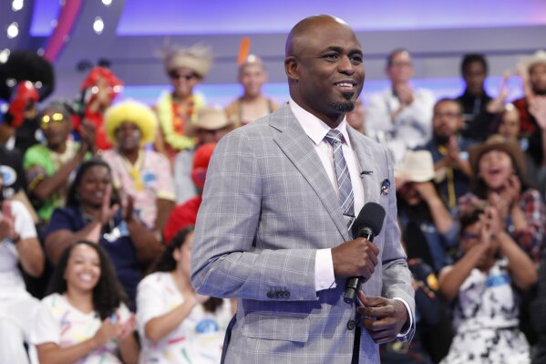 This image released by CBS shows host Wayne Brady on the set of the gameshow "Let's Make a Deal." Shut-in television viewers tuned in to the game show “Let’s Make a Deal” in record numbers last week. The Nielsen company said the show recorded its best week in the 11 years since it was revived by CBS with Wayne Brady as host. (Monty Brinton/CBS via AP)