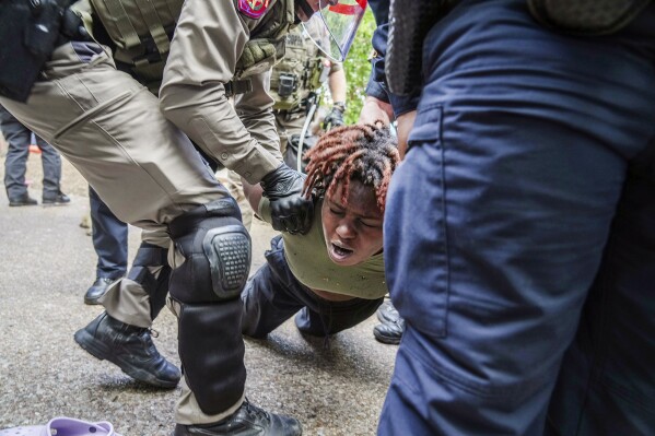 A demonstrator is restrained by police at a pro-Palestinian protest at the University of Texas, Wednesday, April 24, 2024, in Austin, Texas. (Ricardo B. Brazziell/Austin American-Statesman via AP)