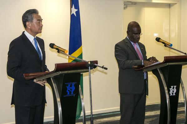 China's Foreign Minister Wang Yi, left, and his counterpart from the Solomon Islands, Jeremiah Manele hold a joint news conference in Honiara, Solomon Islands, early Thursday, May 26, 2022. Wang and a 20-strong delegation have arrived in the Solomon Islands at the start of an eight-nation Pacific tour that comes amid growing concerns about Beijing's military and financial ambitions in the region. (AP Photo)