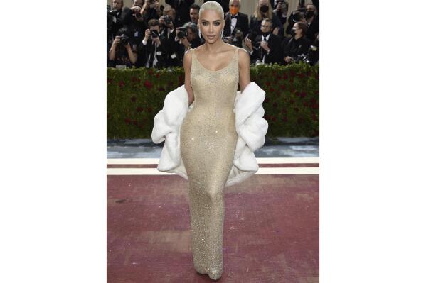 FILE - Kim Kardashian wears the iconic dress worn by Marilyn Monroe at The Metropolitan Museum of Art's Costume Institute benefit gala in New York on May 2, 2022.  Some Monroe enthusiasts believe the dress was damaged after Kardashian wore it but the Ripley’s Believe It or Not! attraction in Hollywood, Calif., where the garment is on display, denies that claim. (Photo by Evan Agostini/Invision/AP, File)