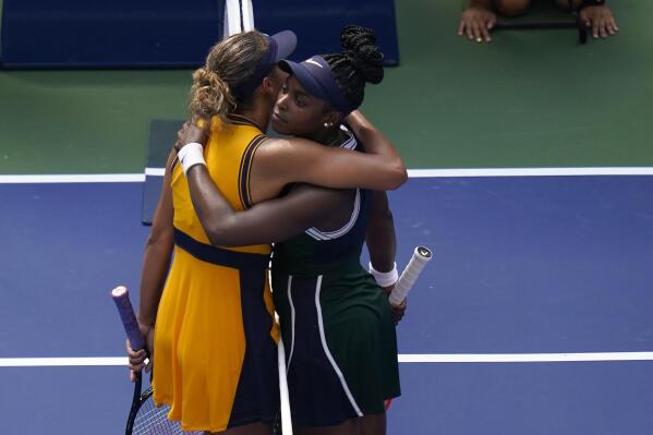 Sloane Stephens, of the United States, right, hugs Madison Keys, of the United States, after winning their first-round match of the US Open tennis championships, Monday, Aug. 30, 2021, in New York. (AP Photo/Seth Wenig)