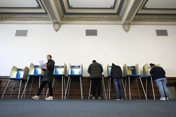 Voters mark their ballots while voting at Centennial Hall at the Milwaukee Central Library on Election Day Tuesday, April 1, 2025, in Milwaukee. (AP Photo/Kayla Wolf)