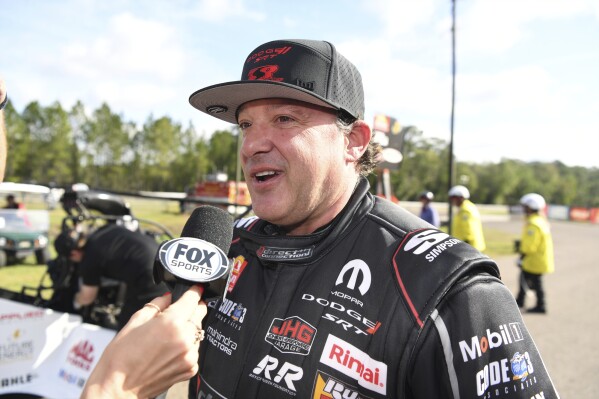 In this photo provided by the NHRA, driver/owner Tony Stewart talks to Fox Sports following his loss in the opening round of eliminations at the Gatornationals drag races at Gainesville Raceway in Gainesville, Fla., Sunday, March 10, 2024. Stewart made his Top Fuel debut in the season-opening event. ( Jerry Foss/NHRA/National Dragster via AP)