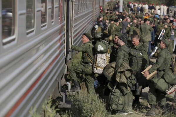 FILE - Russian recruits take a train at a railway station in Prudboi, Volgograd region of Russia, Sept. 29, 2022. As Vladimir Putin heads for another six-year term as Russia’s president, there’s little electoral drama in the race. What he does after he crosses the finish line, however, is what’s drawing attention and, for many observers, provoking anxiety. Probably the most unpopular move he could make at home would be to order a second military mobilization to fight in Ukraine. (AP Photo/File)
