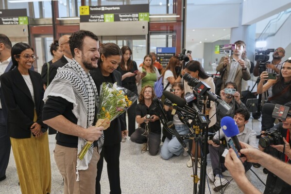 Mahmoud Khalil, second from left, alongside Rep. Alexandria Ocasio-Cortez, prepares to speak at a news conference upon arriving at Newark International Airport, Saturday, June 21, 2025, in Newark, N.J. (AP Photo/Seth Wenig)