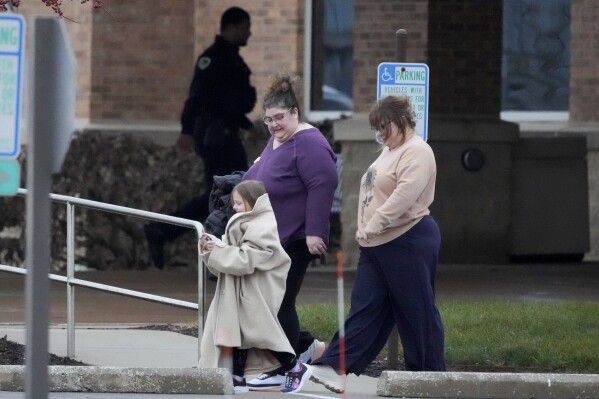 A family leaves the SSMI Health Center, set up as an reunification center, in Madison, Wis., following a shooting, Monday, Dec. 16, 2024. (AP Photo/Morry Gash)