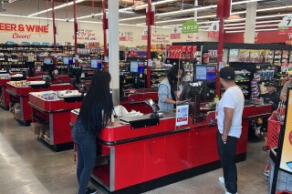 Customers check out at a Grocery Outlet store in Pleasanton, Calif. on Thursday, Sept. 15, 2022.  (AP Photo/Terry Chea)