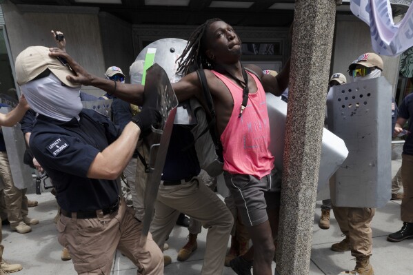 FILE - Charles Murrell fends off a marcher from a group bearing insignias of the white supremacist group Patriot Front on July 2, 2022, in Boston. The Black musician who says members of the white nationalist hate group punched, kicked and beat him with metal shields during a march through Boston last year sued the organization on Tuesday, Aug. 8, 2023. (AP Photo/Michael Dwyer, file)