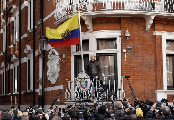 FILE - WikiLeaks founder Julian Assange gestures on the balcony of the Ecuadorian embassy prior to speaking, in London, May 19, 2017. WikiLeaks founder Julian Assange is facing what could be his final court hearing in England over whether he should be extradited to the United States to face spying charges. The High Court will hear two days of arguments next week over whether Assange can make his pitch to an appeals court to block his transfer to the U.S. (AP Photo/Matt Dunham, File)