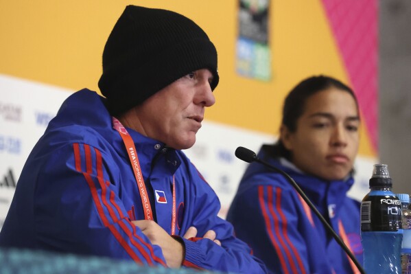 Head coach Alen Stajcic and Philippines Defender Hali Long speak at the press conference before the Philippines soccer match against Switzerland at the Women's World Cup in Dunedin, New Zealand, Thursday, July 20, 2023. For a nation more than 7,000 miles from the United States, the Philippines boasts a women's national soccer team with a decidedly American feel. Of the 23 names on its Women's World Cup roster, 18 belong to U.S.-born women. (AP Photo/Matthew Gelhard)