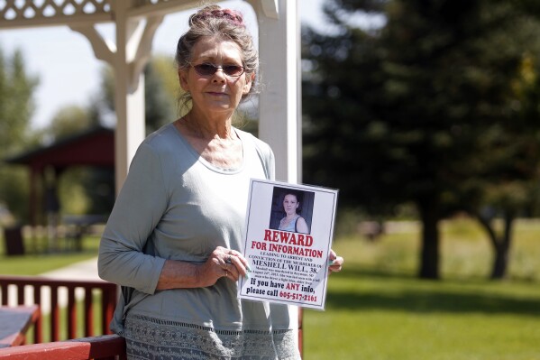 FILE - Nancy Herman holds a reward poster for information about the death of her friend Meshell Will, in Cluster, S.D., on Aug. 22. 2017. A South Dakota man has been sentenced, Friday, March 22, 2024, to 10 years in prison for manslaughter in the 2013 death of his girlfriend, Meshell Will,(Chris Huber/Rapid City Journal via AP, File)