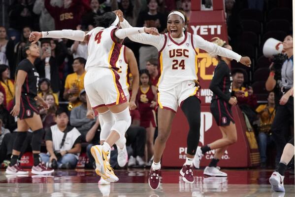 Southern California guard Kayla Williams, left, and guard Okako Adika celebrates after USC upset Stanford 55-46 in an NCAA college basketball game Sunday, Jan. 15, 2023, in Los Angeles. (AP Photo/Mark J. Terrill)