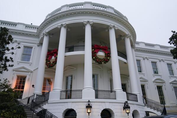 FILE - Wreaths hang on the Truman Balcony of the White House in Washington, Nov. 27, 2022. President Joe Biden celebrated a quiet Christmas with his family at the White House over a record-setting cold and windy weekend in the nation’s capitol. (AP Photo/Susan Walsh, File)