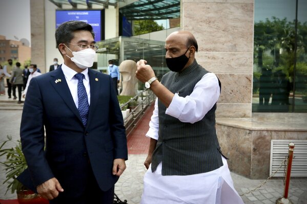 Indian Defense Minister Rajnath Singh welcomes South Korea’s Minister of National Defense Suh Wook as the latter arrives for a ceremonial reception in New Delhi, India, Friday, March 26, 2021. (AP Photo/Manish Swarup)