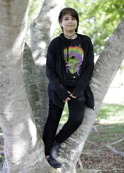 
              FILE - In this Thursday, May 14, 2015 file photo, Alex Ramos, 13, who now goes by the name Theo Ramos, poses for a photograph in a park near his home in Homestead, Fla. “When you’re 10 years old, you really shouldn’t be worried about who you are,” Theo would say years later, in a moment of reflection. “You shouldn’t be having that existential question when you’re in fifth grade. You should be worried about homework and the fifth-grade dance coming up.” (AP Photo/Lynne Sladky)
            