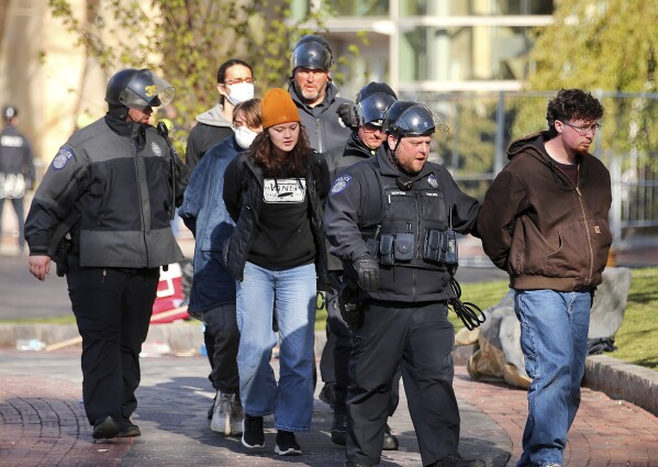 Northeastern University police remove and arrest protesters one by one at the tent encampment on the Boston campus on Saturday, April 27, 2024. Dozens of Nude students and other protesters who set up tents with They on the Nude campus were arrested by the State, Boston and Nude Police.  (John Tumacki/The Boston Globe via AP)