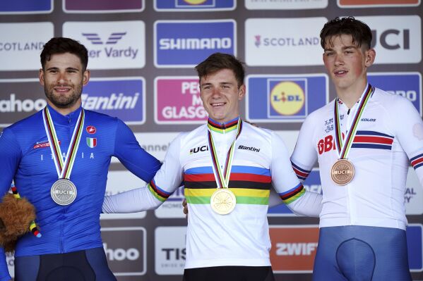 Belgium's Remco Evenepoel, centre, with the gold medal, Italy's Filippo Ganna, left, with the silver medal and Great Britain's Joshua Tarling with the bronze medal after the Men Elite Individual Time Trial on day nine of the 2023 UCI Cycling World Championships in Stirling, Britain, Friday Aug. 11, 2023. (Tim Goode/PA via AP)