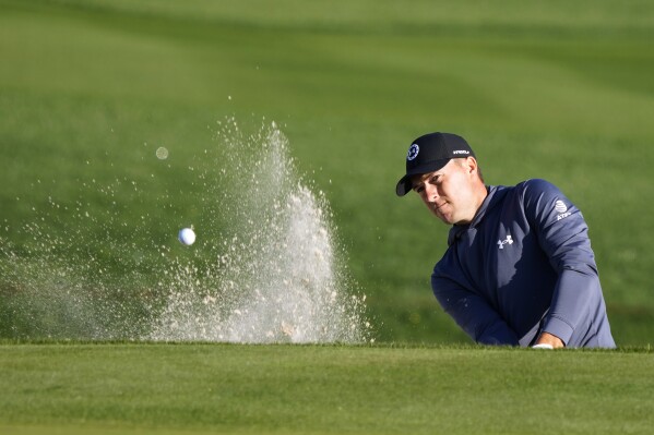 Jordan Spieth blasts from the sand trap along the 11th green during the first round of The Players Championship golf tournament Thursday, March 14, 2024, in Ponte Vedra Beach, Fla. (AP Photo/Lynne Sladky)