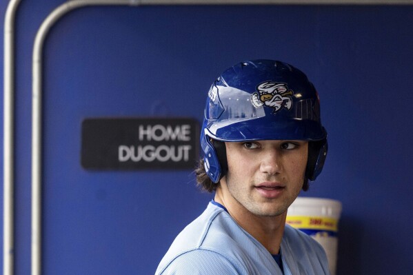 The Omaha Storm Chasers' Jac Caglianone waits in the dugout before his at-bat in a minor league baseball game against St. Paul at Werner Park in Papillion, Neb. on May 27, 2025. (Chris Machian/Omaha World-Herald via AP, file)