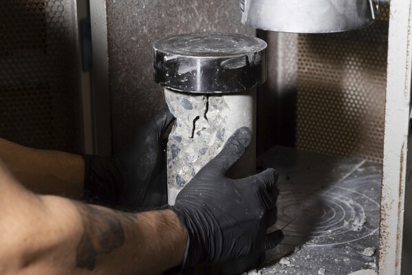 A concrete cylinder is removed after being tested for compressive strength at Fortera's facility in San Jose, Calif., Wednesday, April 10, 2024. The cement industry is one of the largest emitters of carbon dioxide and is responsible for about 8% of global emissions each year. Fortera, a clean tech company whose technology captures carbon emissions from kilns and feeds it back in to the process, is opening its first commercial scale operation on Thursday, April 12, 2024, in California. (AP Photo/Benjamin Fanjoy)