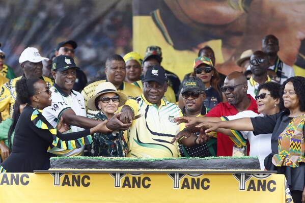 African National Congress (ANC) President Cyril Ramaphosa cuts a cake with supporters at the Dr Molemela stadium in Mangaung, South Africa, Sunday, Jan 8, 2023. The ANC marks its 111st anniversary with celebratory events in Mangaung, Free State province, where the organization was founded in 1912. (AP Photo)