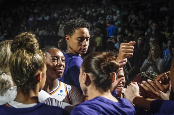 Phoenix Mercury center Brittney Griner, center, join teammates in a cheer at the start of a WNBA basketball game against New York Liberty, Sunday, June 18, 2023, in New York. (AP Photo/Bebeto Matthews)