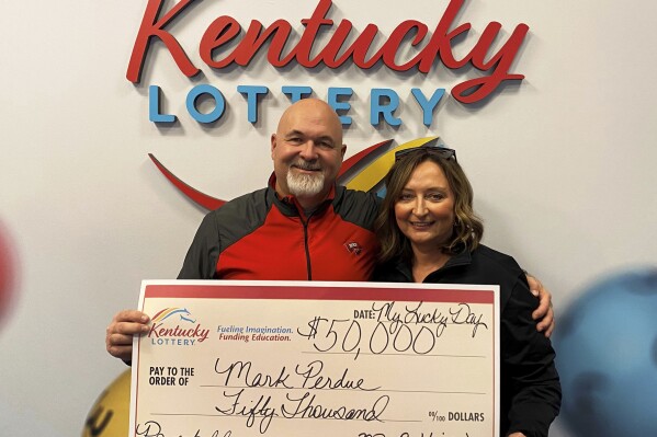 In this recent image provided by Kentucky Lottery, Mark Perdue and his wife pose at the Kentucky Lottery's headquarters in Louisville, Ky. Luck struck twice for the Kentucky couple who thought they lost a winning Powerball ticket. The Bowling Green couple found out about a week after purchasing the ticket in late October that they had won $50,000, but they couldn't find the ticket, the Kentucky Lottery said in a statement. Three months later, Perdue went to check out the condition of a car at work and saw the ticket inside. The couple claimed $36,000 after taxes the following day. (Kentucky Lottery via AP)