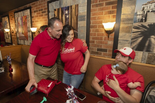 Rep. Bob Good, left, a candidate in the Republican primary for the state's 5th Congressional District, greets family members at a watch party in Lynchburg, Va., Tuesday, June 18, 2024. (AP Photo/P. Kevin Morley)