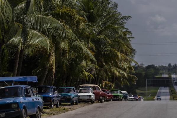 People wait in line to be able to refuel their cars in Havana, Cuba, Monday, April 24, 2023. Cuba’s capital has been restricting fuel sales, threatening to further weaken an economy reeling from power blackouts and rampant inflation. (AP Photo/Ramon Espinosa)