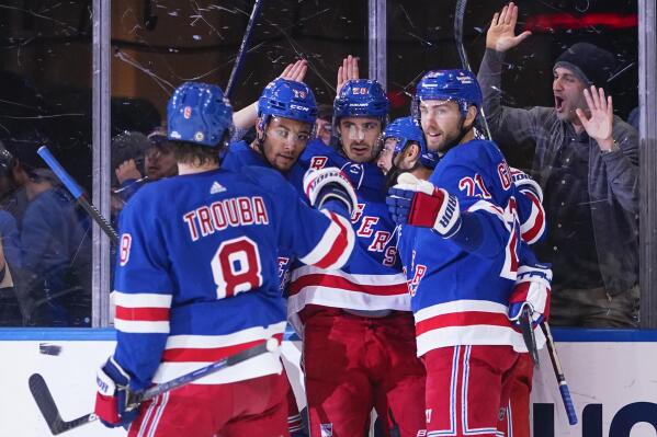 New York Rangers' Chris Kreider (20) celebrates with teammates K'Andre Miller (79), Barclay Goodrow (21) and Jacob Trouba (8) after scoring a goal during the first period of an NHL hockey game against the Vancouver Canucks Wednesday, Feb. 8, 2023, in New York. (AP Photo/Frank Franklin II)