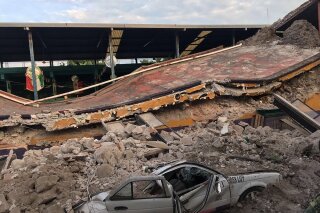 
              A car sits crushed, engulfed in a pile of rubble from a building felled by a 7.1 earthquake, in Jojutla, Morelos state, Mexico, Tuesday, Sept. 19, 2017. The earthquake stunned central Mexico, killing at least 139 people as buildings collapsed in plumes of dust. (AP Photo/Carlos Rodriguez)
            