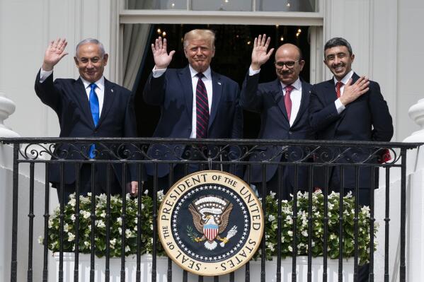 FILE - In this Tuesday, Sept. 15, 2020 file photo, Israeli Prime Minister Benjamin Netanyahu, left, U.S. President Donald Trump, Bahrain Foreign Minister Khalid bin Ahmed Al Khalifa and United Arab Emirates Foreign Minister Abdullah bin Zayed al-Nahyan pose for a photo on the Blue Room Balcony after signing the Abraham Accords during a ceremony on the South Lawn of the White House in Washington. The bloodshed in the Gaza Strip has unleashed a chorus of voices across Gulf Arab states that are fiercely critical of Israel and emphatically supportive of Palestinians. (AP Photo/Alex Brandon, File)