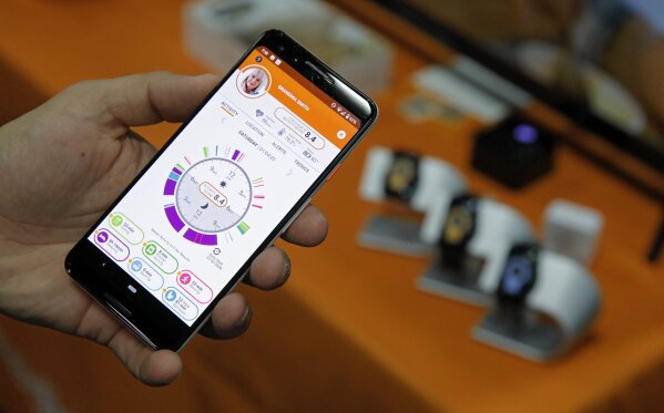 The app for the CarePredict Tempo Series 3 appears on display at the CarePredict booth during CES Unveiled before CES International, Sunday, Jan. 5, 2020, in Las Vegas. The wearable device for seniors detects changes in the senior's activity and can alert caregivers and family. (AP Photo/John Locher)