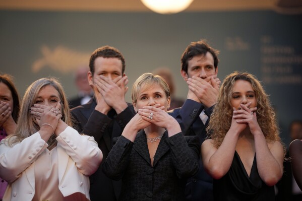 “Me Too” director Judith Godreche, center, poses with hands covering their mouth upon arrival at the premiere of the film ‘Furiosa: A Mad Max Saga’ at the 77th international film festival, Cannes, southern France, Wednesday, May 15, 2024. (Photo by Andreea Alexandru/Invision/AP)