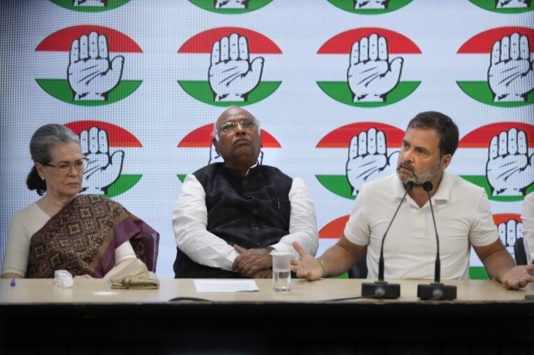 Congress party president Mallikarjun Kharge, center, and senior party leader Sonia Gandhi, left, listen to Rahul Gandhi during a press conference at their party headquarters in New Delhi, India, Thursday, March 21, 2024. (AP Photo/Manish Swarup)